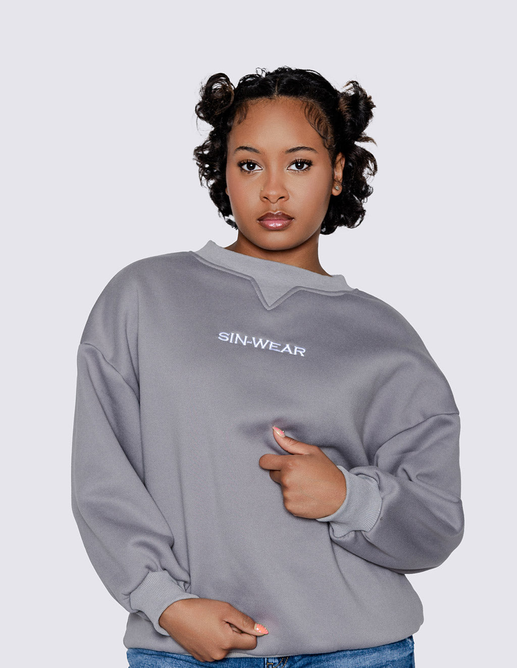 Person wearing a gray sweatshirt with 'SIN-WEAR' branding on a plain background