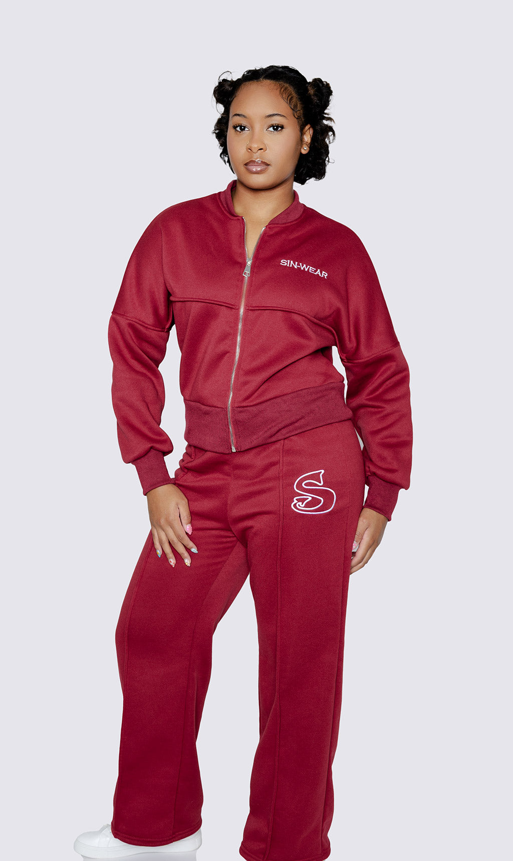Person wearing a red tracksuit with a 'Sin-Wear' logo on a white background