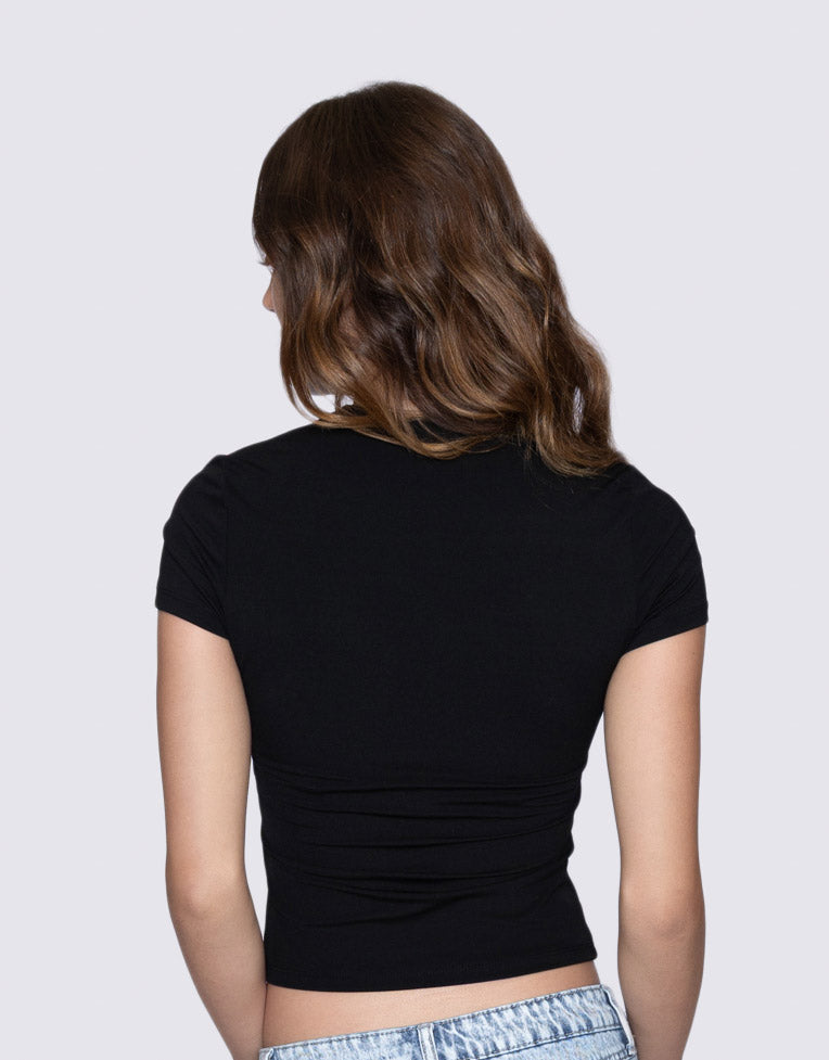 Person wearing a black top on a plain background