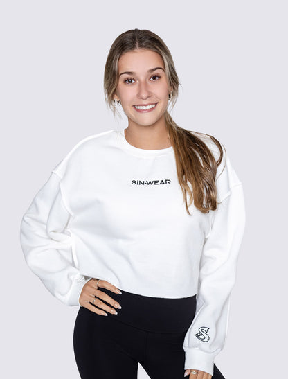 Person wearing a white sweatshirt with 'SIN-WEAR' branding on a plain background