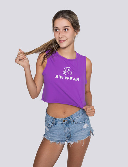 Woman wearing a purple 'Sin-Wear' tank top and denim shorts on a plain background