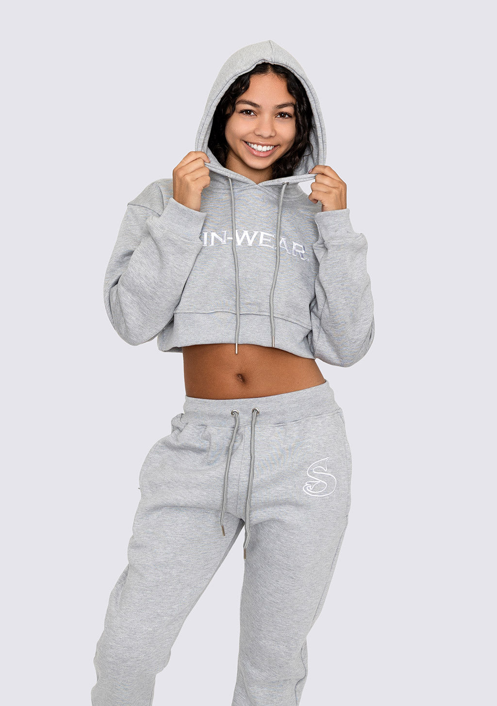 Person wearing a gray hoodie and sweatpants with Sin-Wear branding on a white background