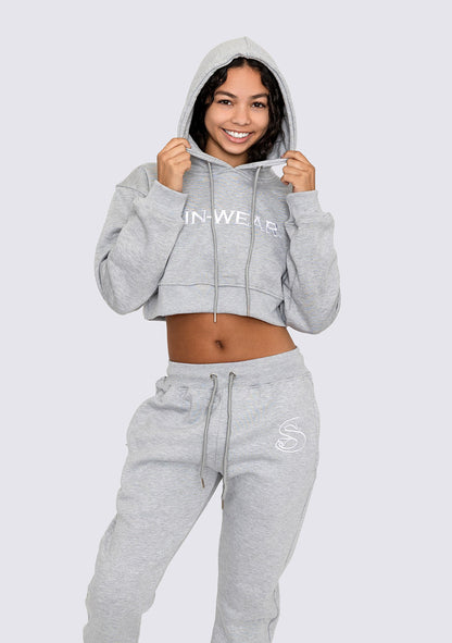Person wearing a gray hoodie and sweatpants with Sin-Wear branding on a white background