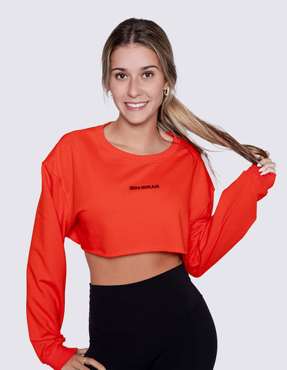 Woman wearing a red crop top with 'Sin-Wear' branding on a white background