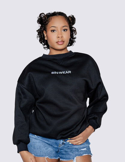 Person wearing a black hoodie with 'Sin-Wear' logo on a light gray background