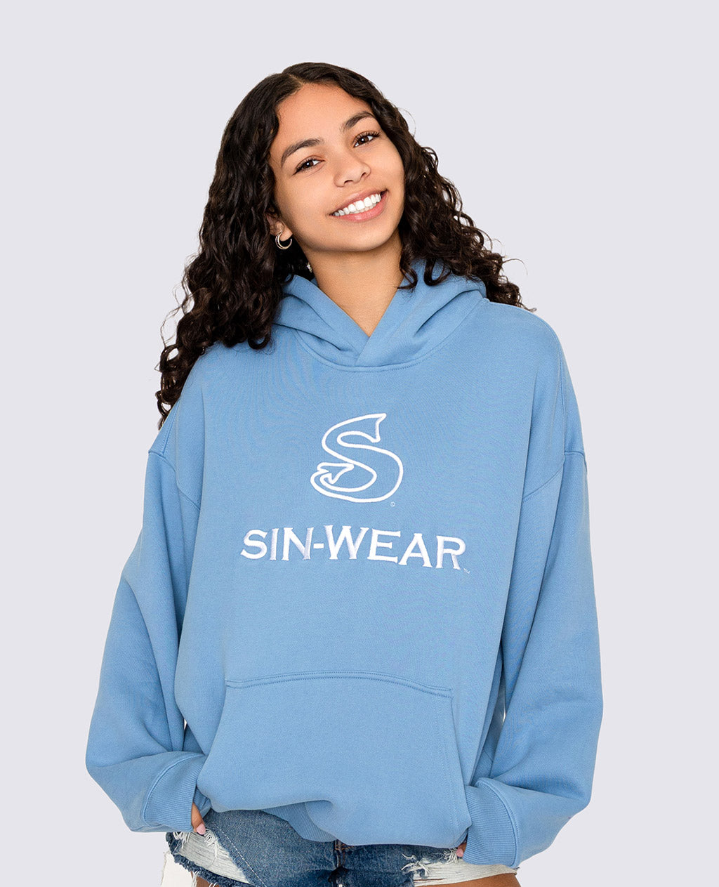 Person wearing a blue hoodie with 'SIN-WEAR' logo on a light gray background