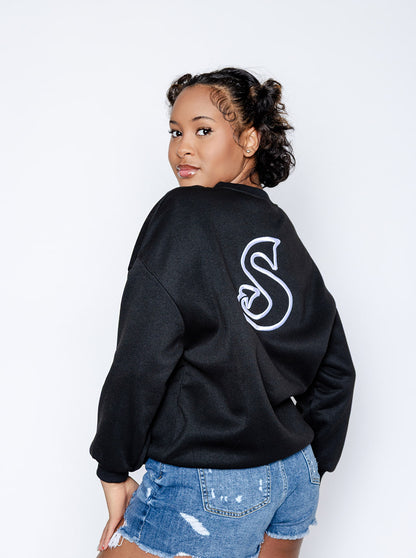 Person wearing a black sweatshirt with a white 'Sin-Wear' logo on the back, standing against a plain background.