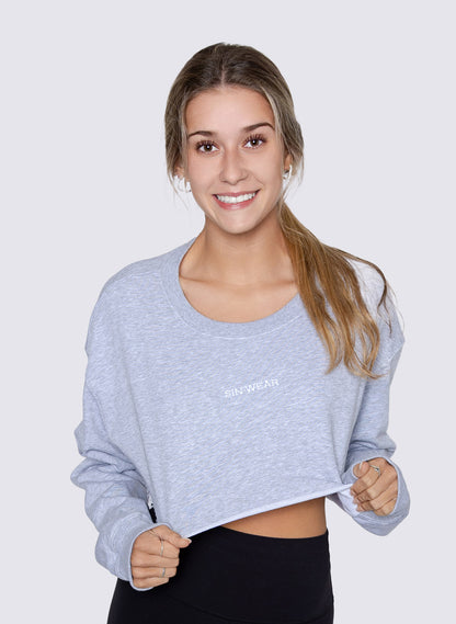 Woman wearing a gray cropped sweatshirt with 'Sin-Wear' brand logo on a white background