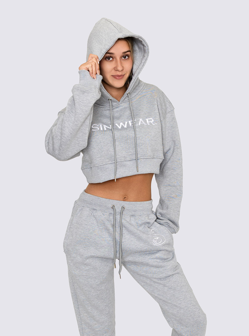 Person wearing a gray hoodie and pants with 'Sin-Wear' branding on a white background