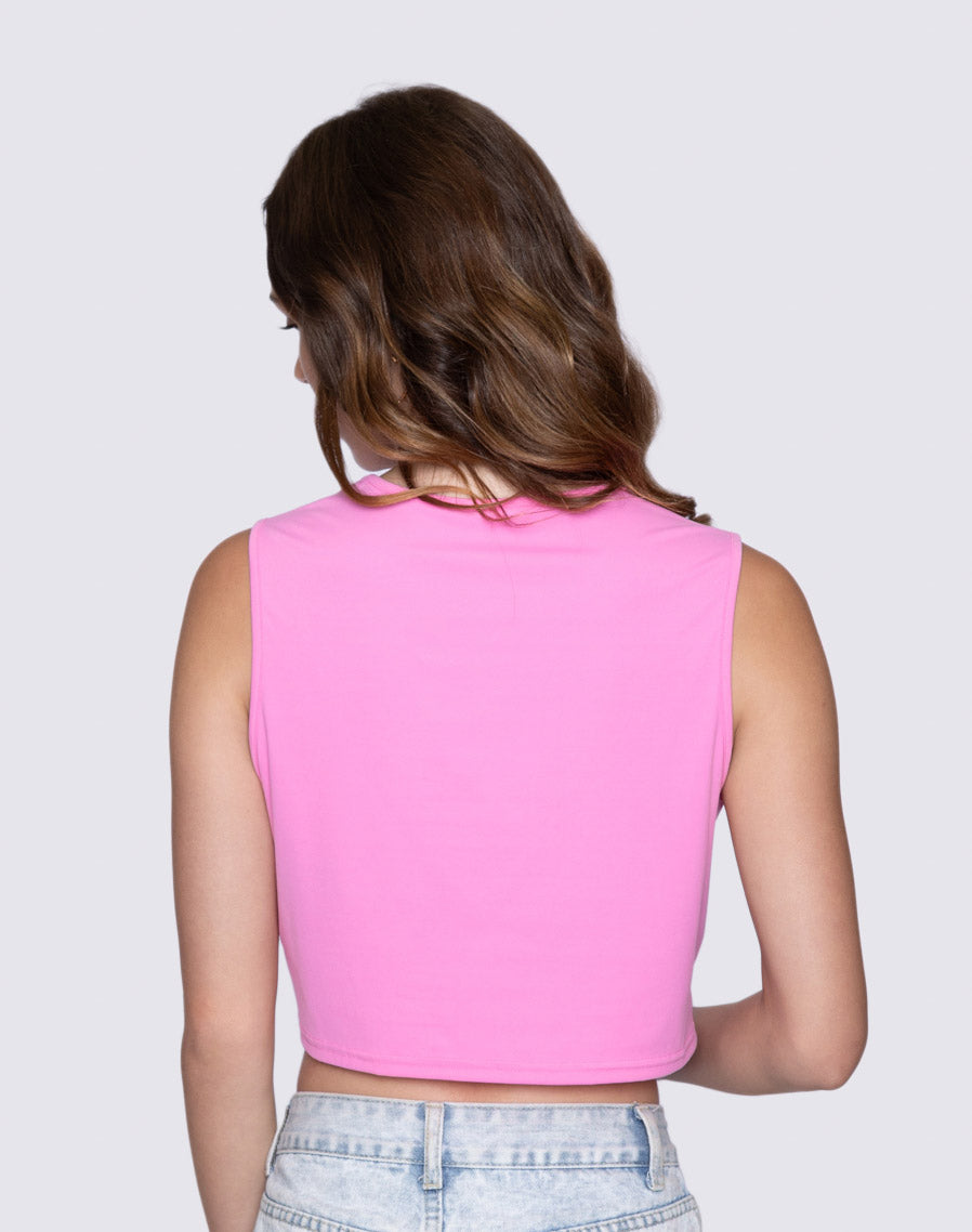 Person wearing a pink 'Sin-Wear' sleeveless top on a plain background