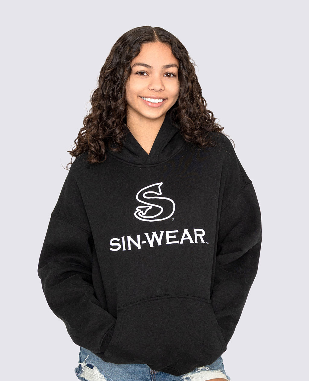 Person wearing a black hoodie with 'SIN-WEAR' logo on a light gray background