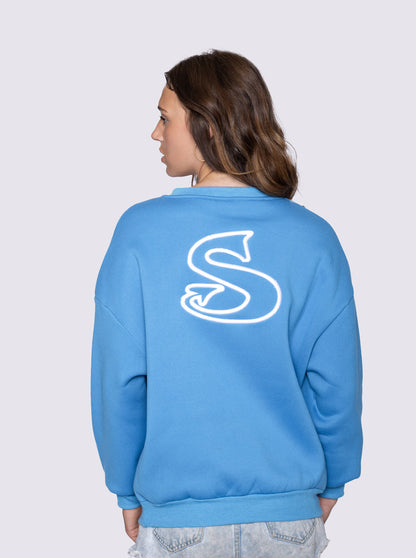 Person wearing a blue sweatshirt with a white 'Sin-Wear' on the back against a light gray background